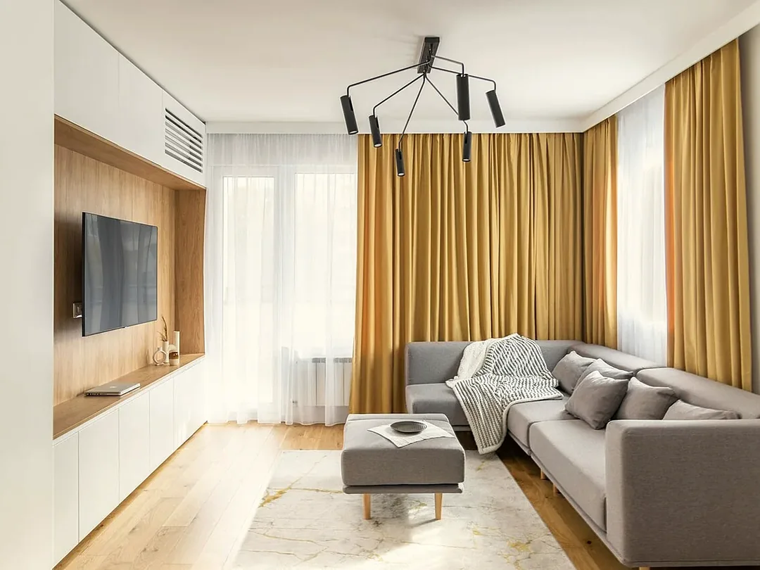 Heller moderner Wohnraum mit Sofa, Vorhängen und großen Fenstern